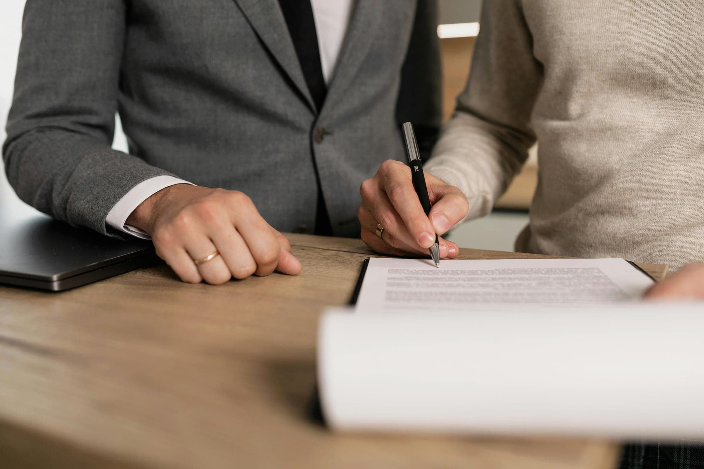 Signing an agreement at a desk